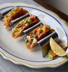 The Whale Chicago signature dishes Lobster Tacos, Buffalo Fried Cauliflower, Baltimore Crab Rolls.